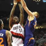 Portland Trail Blazers forward Ed Davis (17) drives to the basket on Phoenix Suns center Alex Len (21) during the fourth quarter of an NBA basketball game in Portland, Ore., Saturday, Oct. 31, 2015. The Suns won the game 101-90. (AP Photo/Steve Dykes)