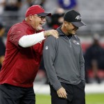 Arizona Cardinals head coach Bruce Arians, left, and Baltimore Ravens head coach John Harbaugh talk prior to an NFL football game, Monday, Oct. 26, 2015, in Glendale, Ariz. (AP Photo/Ross D. Franklin)