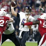 Baltimore Ravens quarterback Joe Flacco (5) throws under pressure from Arizona Cardinals defensive end Frostee Rucker (92) and Rodney Gunter (95) during the first half of an NFL football game, Monday, Oct. 26, 2015, in Glendale, Ariz. (AP Photo/Rick Scuteri)