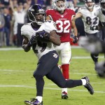 Baltimore Ravens running back Justin Forsett (29) runs in for a touchdown as Arizona Cardinals free safety Tyrann Mathieu (32) pursues during the first half of an NFL football game, Monday, Oct. 26, 2015, in Glendale, Ariz. (AP Photo/Rick Scuteri)
