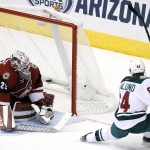 Minnesota Wild's Mikael Granlund (64), of Finland, scores against Arizona Coyotes' Anders Lindback, of Sweden, during the second period of an NHL hockey game Thursday, Oct. 15, 2015, in Glendale, Ariz. (AP Photo/Ross D. Franklin)