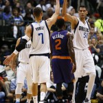 Dallas Mavericks' Salah Mejri (50) celebrates his score with Dwight Powell (7) in front of Phoenix Suns' Eric Bledsoe (2) during the first half of a preseason NBA basketball game, Wednesday, Oct. 21, 2015, in Dallas. (AP Photo/Jim Cowsert)