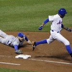 New York Mets' Curtis Granderson is safe at first as Kansas City Royals' Eric Hosmer can't touch the bag during the fifth inning of Game 4 of the Major League Baseball World Series Saturday, Oct. 31, 2015, in New York. (AP Photo/Frank Franklin II)