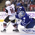 Toronto Maple Leafs goaltender James Reimer, right, makes a save as Maple Leafs defenceman Matt Hunwick, centre, battles with Arizona Coyotes' Max Domi for a rebound during first period NHL hockey action in Toronto on Monday, Oct. 26, 2015. (Frank Gunn/The Canadian Press via AP)