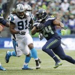 Seattle Seahawks running back Marshawn Lynch rushes against Carolina Panthers' Ryan Delaire (91) in the second half of an NFL football game, Sunday, Oct. 18, 2015, in Seattle. (AP Photo/Elaine Thompson)