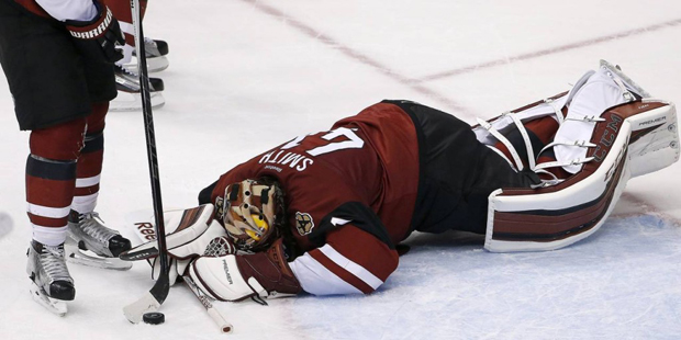 Arizona Coyotes' Mike Smith gives up a goal to Boston Bruins' David Krejci, of the Czech Republic, ...