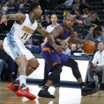 Phoenix Suns forward P.J. Tucker, right, looks to pass the ball as Denver Nuggets forward Wilson Chandler covers in the first half of an NBA preseason basketball game Friday, Oct. 16, 2015, in Denver. (AP Photo/David Zalubowski)