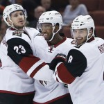 Arizona Coyotes' Oliver Ekman-Larsson (23),  Anthony Duclair and Tobias Rieder (8) celebrate a goal by Duclair during the first period of an NHL hockey game against the Anaheim Ducks in Anaheim, Calif., Wednesday, Oct. 14, 2015. (AP Photo/Christine Cotter)