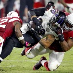 Baltimore Ravens tight end Crockett Gillmore (80) his tackled by Arizona Cardinals free safety Tyrann Mathieu (32) and Tony Jefferson (22) during the second half of an NFL football game, Monday, Oct. 26, 2015, in Glendale, Ariz. (AP Photo/Ross D. Franklin)