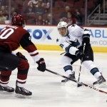 San Jose Sharks defenseman Justin Braun (61) makes the pass in front of Arizona Coyotes center Dylan Strome in the second period during a preseason NHL hockey game, Friday, Oct. 2, 2015, in Glendale, Ariz. (AP Photo/Rick Scuteri)