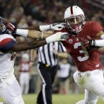 Stanford's Michael Rector (3) stiff arms Arizona 's DaVonte' Neal on an 18-yard touchdown reception during the second half of an NCAA college football game Saturday, Oct. 3, 2015, in Stanford, Calif.  (AP Photo/Marcio Jose Sanchez)