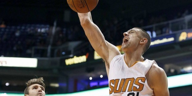 Phoenix Suns' Alex Len (21), of Ukraine, dunks as Utah Jazz's Jeff Withey, left, and Trey Lyles (41...