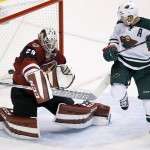 Arizona Coyotes' Anders Lindback (29), of Sweden, makes a save on a shot as Minnesota Wild's Zach Parise watches during the third period of an NHL hockey game Thursday, Oct. 15, 2015, in Glendale, Ariz.  The Wild defeated the Coyotes 4-3. (AP Photo/Ross D. Franklin)