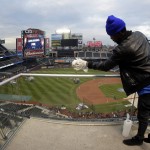 A stadium worker wipes down the glass before Game 4 of the Major League Baseball World Series between the Kansas City Royals and the New York Mets Saturday, Oct. 31, 2015, in New York. (AP Photo/Charlie Riedel)