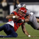 Arizona quarterback Anu Solomon, front, is stopped by Colorado linebacker N.J. Falo after a short gain in the first half of an NCAA college football game Saturday, Oct. 17, 2015, in Boulder, Colo. (AP Photo/David Zalubowski)