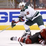 Minnesota Wild's Thomas Vanek, left, of Austria, controls the puck just before scoring a goal as Arizona Coyotes' Michael Stone, right, slides in to defend during the first period of an NHL hockey game Thursday, Oct. 15, 2015, in Glendale, Ariz. (AP Photo/Ross D. Franklin)