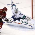 Arizona Coyotes' Tobias Rieder (8), of Germany, scores a goal against Vancouver Canucks' Richard Bachman (32) during the third period of an NHL hockey game Friday, Oct. 30, 2015, in Glendale, Ariz. The Canucks defeated the Coyotes 4-3. (AP Photo/Ross D. Franklin)