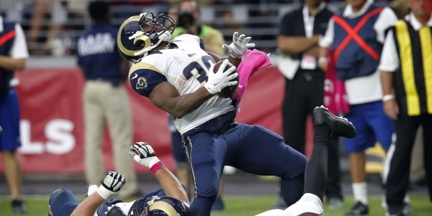 St. Louis Rams running back Benny Cunningham (36) spins around the tackle of Arizona Cardinals free...