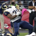 St. Louis Rams running back Benny Cunningham (36) spins around the tackle of Arizona Cardinals free safety Rashad Johnson (26) during the second half of an NFL football game, Sunday, Oct. 4, 2015, in Glendale, Ariz. (AP Photo/Rick Scuteri)