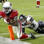 Arizona Cardinals wide receiver John Brown (12) scores a touchdown as Baltimore Ravens cornerback Jimmy Smith (22) defends during the second half of an NFL football game, Monday, Oct. 26, 2015, in Glendale, Ariz. (AP Photo/Rick Scuteri)