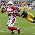 Arizona Cardinals wide receiver Michael Floyd (15) tries to escape Pittsburgh Steelers cornerback Antwon Blake (41) after making a catch in the second quarter of an NFL football game, Sunday, Oct. 18, 2015 in Pittsburgh. (AP Photo/Gene J. Puskar)