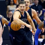 Phoenix Suns' Mirza Teletovic (35), of Bosnia & Herzegovina, chases down a loose ball with Dallas Mavericks' Devin Harris (34) and Wesley Matthews (23) during the first half of an NBA basketball game, Wednesday, Oct. 28, 2015, in Phoenix. (AP Photo/Matt York)