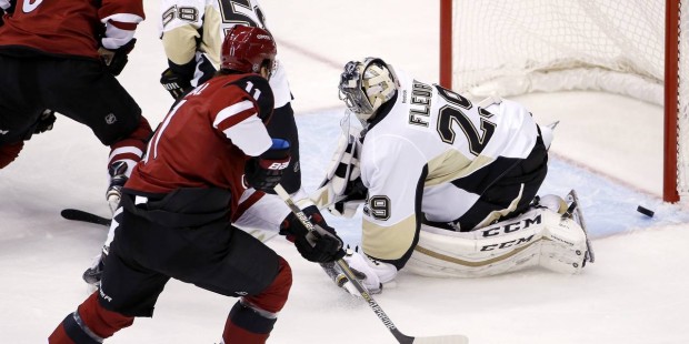 Pittsburgh Penguins' Marc-Andre Fleury (29) makes a save on a shot by Arizona Coyotes' Martin Hanza...