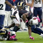 Arizona Cardinals running back David Johnson (31) is hit by St. Louis Rams outside linebacker Alec Ogletree (52) and safety Mark Barron (26) during the first half of an NFL football game, Sunday, Oct. 4, 2015, in Glendale, Ariz. (AP Photo/Rick Scuteri)