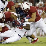 Arizona running back Nick Wilson is tackled by Stanford linebacker Blake Martinez, right, during the first half of an NCAA college football game Saturday, Oct. 3, 2015, in Stanford, Calif.  (AP Photo/Marcio Jose Sanchez)