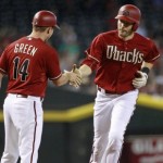 Arizona Diamondbacks' A.J. Pollock, right, is congratulated by third base Andy Green after hitting a solo home run against the Houston Astros during the first inning of a baseball game, Sunday, Oct. 4, 2015, in Phoenix. (AP Photo/Ralph Freso)