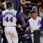 Arizona Diamondbacks' Paul Goldschmidt (44) is greeted by manager Chip Hale after scoring on an RBI double by teammate Welington Castillo during the seventh inning of a baseball game against the Colorado Rockies, Thursday, Oct. 1, 2015, in Phoenix. (AP Photo/Matt York)