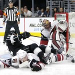 Los Angeles Kings' Marian Gaborik (12), of Slovakia, falls over Arizona Coyotes' Klas Dahlbeck(34), of Sweden, as Coyotes goalie Mike Smith watches during the second period of an NHL hockey game, Friday, Oct. 9, 2015, in Los Angeles. (AP Photo/Jae C. Hong)