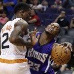 Sacramento Kings' Ben McLemore (23) gets fouled by Phoenix Suns' Eric Bledsoe (2) during the first half of an NBA preseason basketball game Wednesday, Oct. 7, 2015, in Phoenix. (AP Photo/Ross D. Franklin)