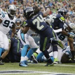 Seattle Seahawks running back Marshawn Lynch (24) scores a touchdown against the Carolina Panthers in the first half of an NFL football game, Sunday, Oct. 18, 2015, in Seattle. (AP Photo/Elaine Thompson)