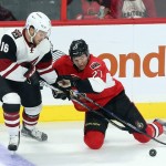 Arizona Coyotes' Max Domi (16) and Ottawa Senators' Curtis Lazar (27) battle for the puck during the first period of an NHL hockey game in Ottawa, Ontario, Saturday, Oct. 24, 2015. (Fred Chartrand /The Canadian Press via AP) MANDATORY CREDIT