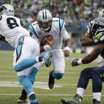 Carolina Panthers quarterback Cam Newton, center, rushes for a touchdown in the first half of an NFL football game against the Seattle Seahawks, Sunday, Oct. 18, 2015, in Seattle. (AP Photo/Elaine Thompson)