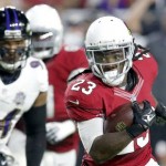 Arizona Cardinals running back Chris Johnson (23) runs for a touchdown as Baltimore Ravens defensive end Carl Davis (94) looks on during the first half of an NFL football game, Monday, Oct. 26, 2015, in Glendale, Ariz. (AP Photo/Rick Scuteri)