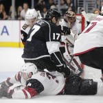 Los Angeles Kings' Milan Lucic, top, takes a tumble over Arizona Coyotes' Klas Dahlbeck, of Sweden, during the second period of an NHL hockey game, Friday, Oct. 9, 2015, in Los Angeles. (AP Photo/Jae C. Hong)