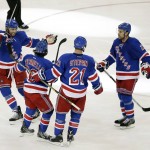 New York Rangers defenseman Keith Yandle (93) celebrates a goal with teammates Mats Zuccarello (36), Derek Stepan (21) and Dan Boyle (22) during the third period of an NHL hockey game  against the Arizona Coyotes, Thursday, Oct. 22, 2015, in New York. The Rangers won 4-1. (AP Photo/Frank Franklin II)
