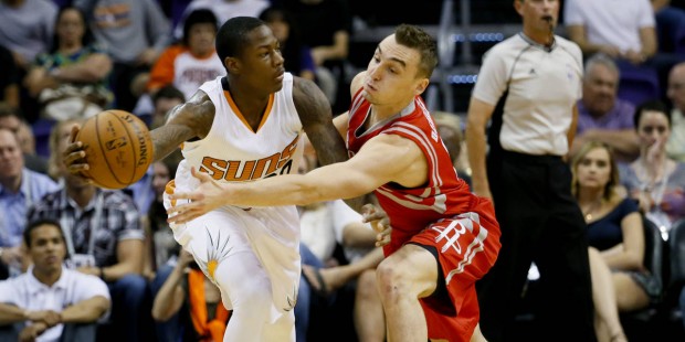 Phoenix Suns' Archie Goodwin, left, passes around Houston Rockets' Sam Dekker during the first half...