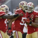San Francisco 49ers linebacker Michael Wilhoite, center, celebrates with strong safety Antoine Bethea, left, and safety Eric Reid after intercepting a throw from Baltimore Ravens quarterback Joe Flacco during the first half of an NFL football game in Santa Clara, Calif., Sunday, Oct. 18, 2015. (AP Photo/Marcio Jose Sanchez)