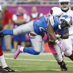 Detroit Lions running back Ameer Abdullah (21) is stopped by Arizona Cardinals free safety Tyrann Mathieu, left, and strong safety Deone Bucannon, right, during the first half of an NFL football game, Sunday, Oct. 11, 2015, in Detroit. (AP Photo/Rick Osentoski)