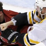 Boston Bruins' Kevan Miller, right, connects with a punch during a fight against Arizona Coyotes' Joe Vitale (14) during the second period of an NHL hockey game Saturday, Oct. 17, 2015, in Glendale, Ariz. (AP Photo/Ross D. Franklin)