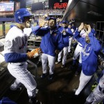 New York Mets' Michael Conforto is congratulated in the dugout after hitting a home run during the third inning of Game 4 of the Major League Baseball World Series against the Kansas City Royals Saturday, Oct. 31, 2015, in New York. (AP Photo/David J. Phillip)