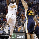 Phoenix Suns' P.J. Tucker (17) shoots over Utah Jazz's Raul Neto (25), of Brazil, during the first half of an NBA preseason basketball game Friday, Oct. 9, 2015, in Phoenix. (AP Photo/Ross D. Franklin)
