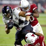 Baltimore Ravens fullback Kyle Juszczyk (44) his hit by Arizona Cardinals free safety Tyrann Mathieu (32) and Deone Bucannon (20) during the first half of an NFL football game, Monday, Oct. 26, 2015, in Glendale, Ariz. (AP Photo/Rick Scuteri)