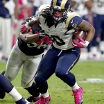 St. Louis Rams running back Todd Gurley (30) eludes the reach of Arizona Cardinals outside linebacker LaMarr Woodley (56) during the second half of an NFL football game, Sunday, Oct. 4, 2015, in Glendale, Ariz. (AP Photo/Rick Scuteri)