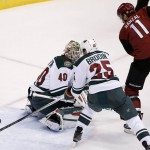 Minnesota Wild's Jonas Brodin (25), of Sweden, clears the puck after a shot by Arizona Coyotes' Martin Hanzal (11), of the Czech Republic, got past Wild goalie Devan Dubnyk (40) during the second period of an NHL hockey game Thursday, Oct. 15, 2015, in Glendale, Ariz. (AP Photo/Ross D. Franklin)