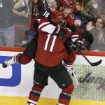 Arizona Coyotes' Max Domi (16) celebrates his goal against the Minnesota Wild with Martin Hanzal (11), of the Czech Republic, during the second period of an NHL hockey game Thursday, Oct. 15, 2015, in Glendale, Ariz. The Wild won 4-3. (AP Photo/Ross D. Franklin)