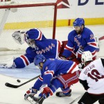 New York Rangers goalie Henrik Lundqvist, top left, stops a shot on goal by Arizona Coyotes' Anthony Duclair (10) during the third period of an NHL hockey game Thursday, Oct. 22, 2015, in New York. The Rangers won 4-1. (AP Photo/Frank Franklin II)